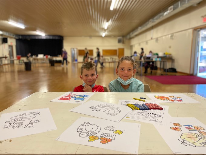 Siblings at a craft table during vaccine clinic at Cobden Agricultural Hall