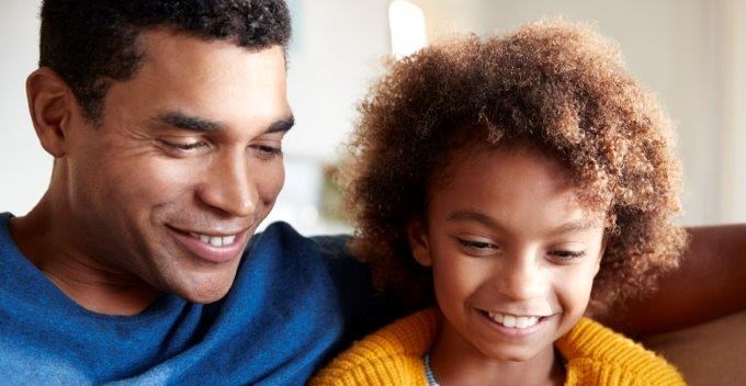 adult and child on a computer together